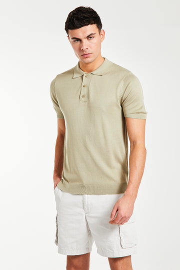 model wearing 'Senza' knitted polo in light beige with shorts