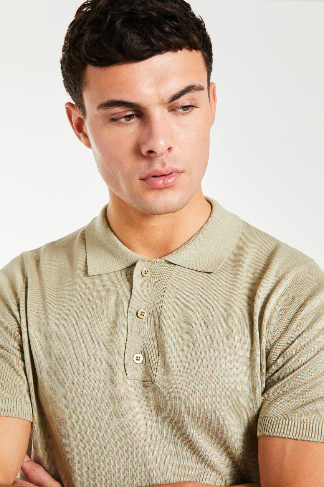close up of men's button up knitted polo in oatmeal