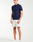 men's knitted polo with button up feature in dark blue styled with shorts