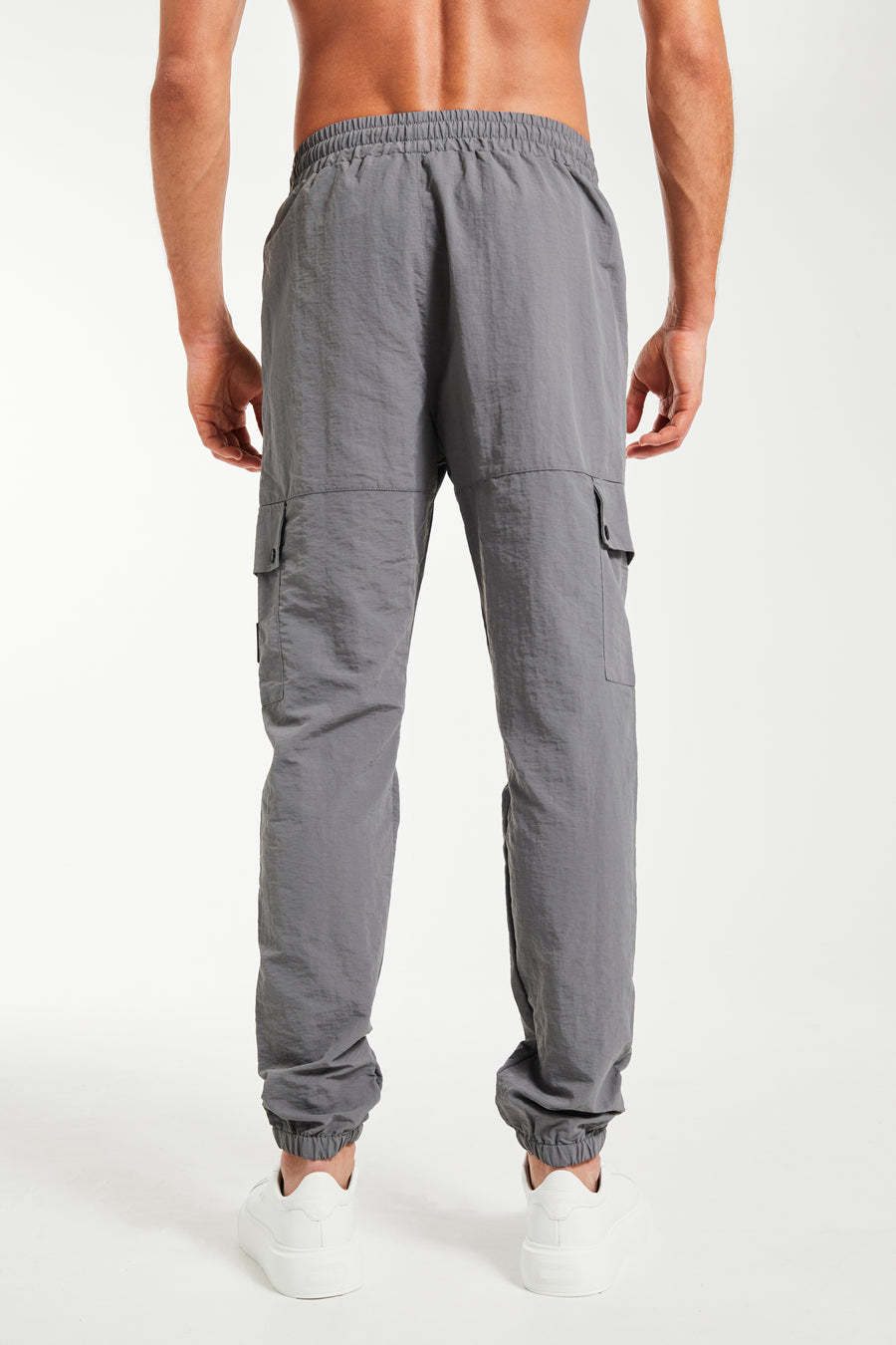 back profile of men's mens cuffed cargo pants sale in charcoal grey