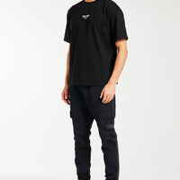 Model styled in cuffed cargo pants sale in all black
