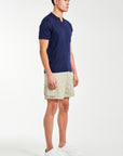 Side profile of a men's knitted polo in navy with shorts