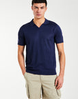 Model wearing navy v-neck men's knitwear polo