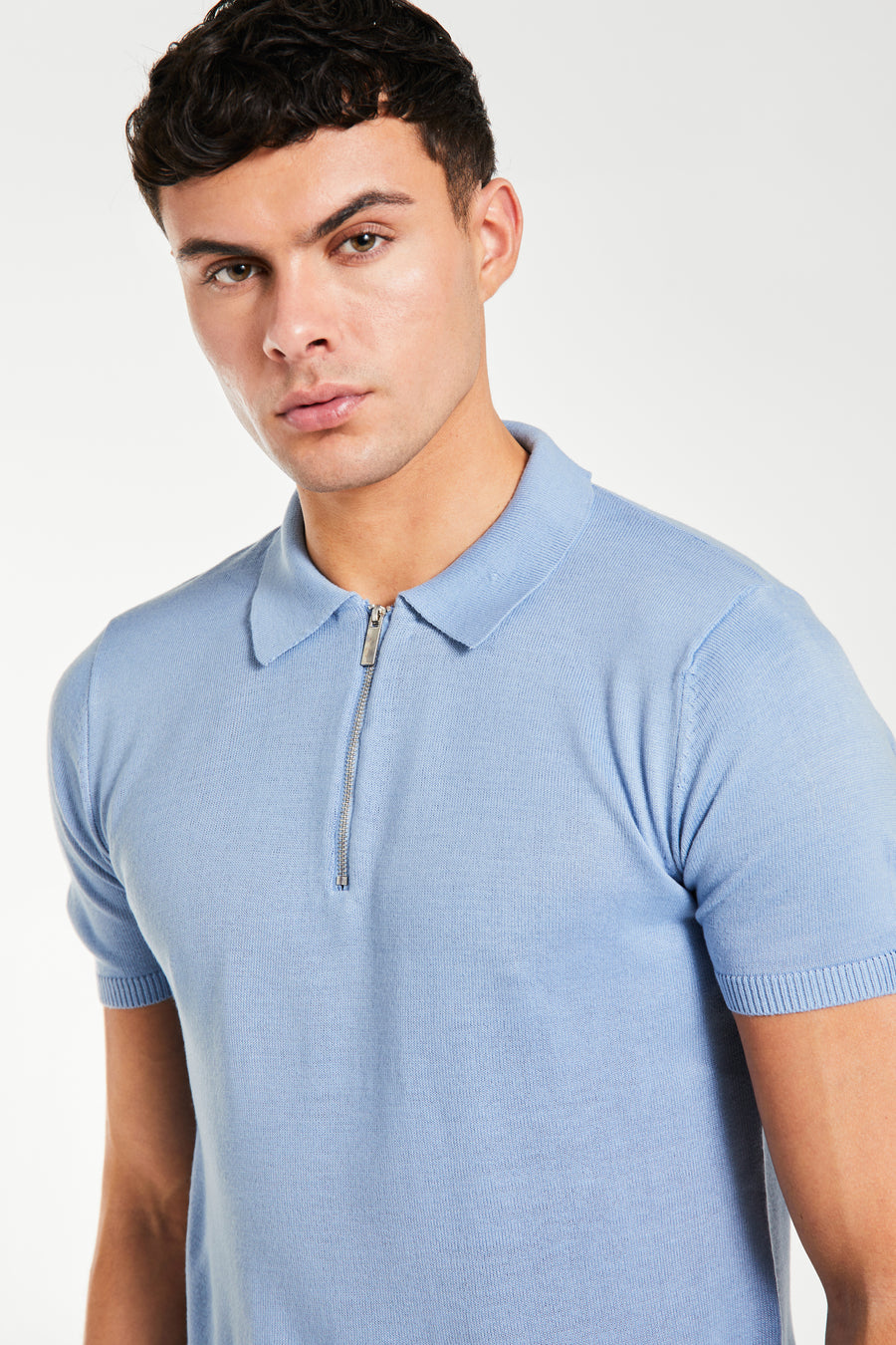 close up of men's knitted polo with zip up collar in light blue