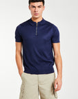 Model wearing navy men's knitted polo with quarter zip 