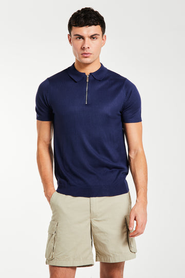 Model wearing navy men's knitted polo with quarter zip 
