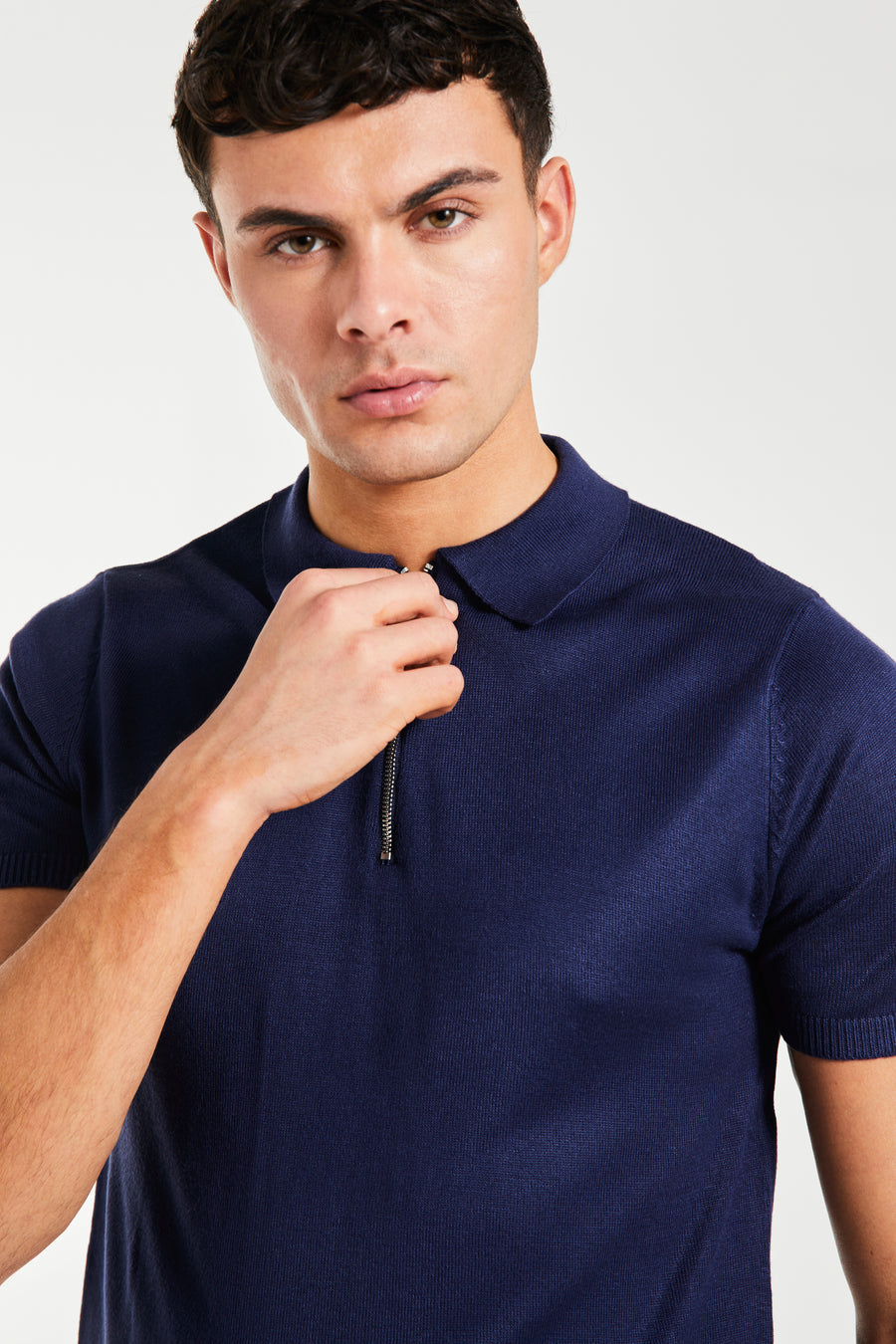 close up of zip knitted polo in a dark blue