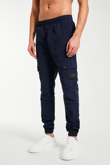 Model wearing men's cargo pants sale with elasticated waist band in navy
