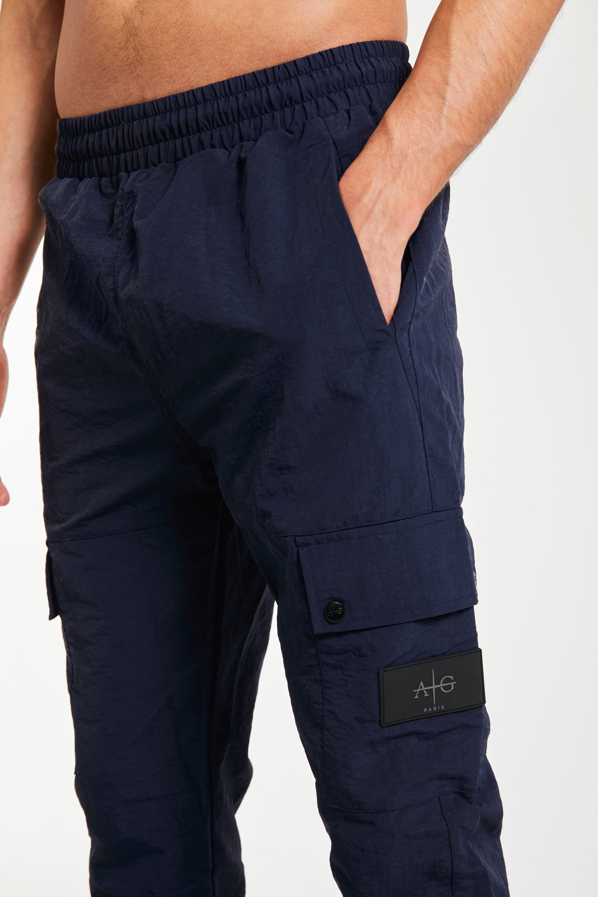 Men&#39;s cuffed cargo pants sale close up showing &#39;Avant Garde Paris&#39; logo in navy blue