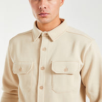 Close up of button up overshirt jacket in cream