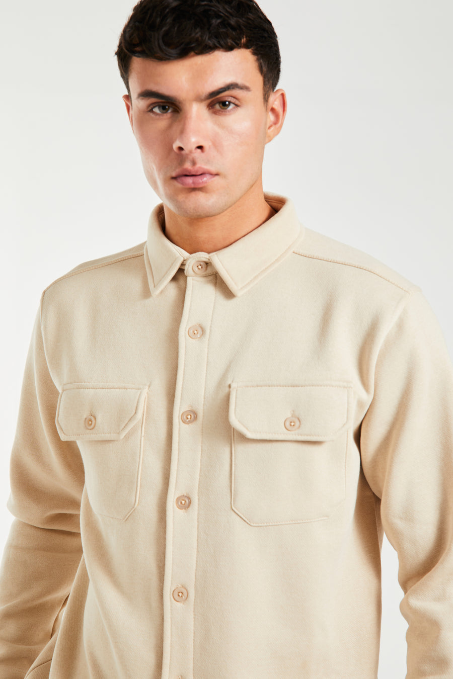 Close up of button up overshirt jacket in cream