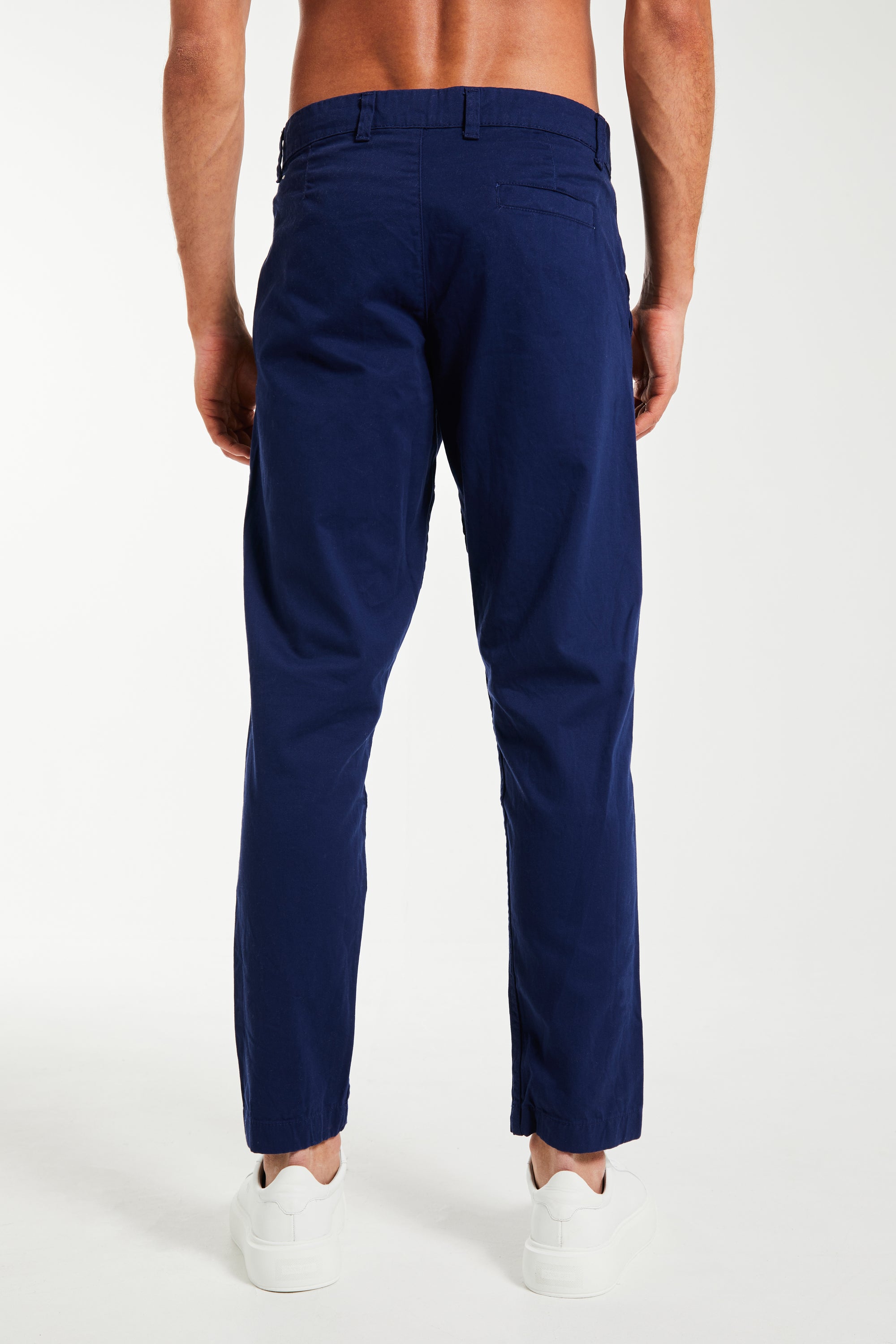 Back profile of men's chino pants in dark blue