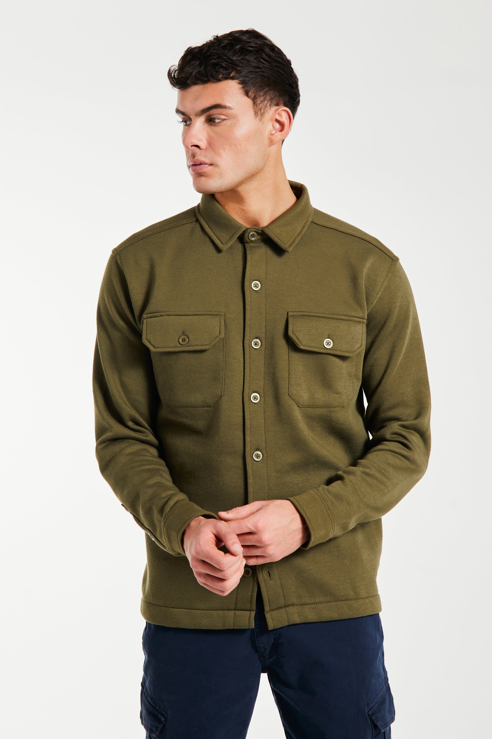 Model wearing khaki green over shirt jacket with buttons
