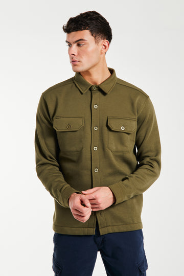 Model wearing khaki green over shirt jacket with buttons