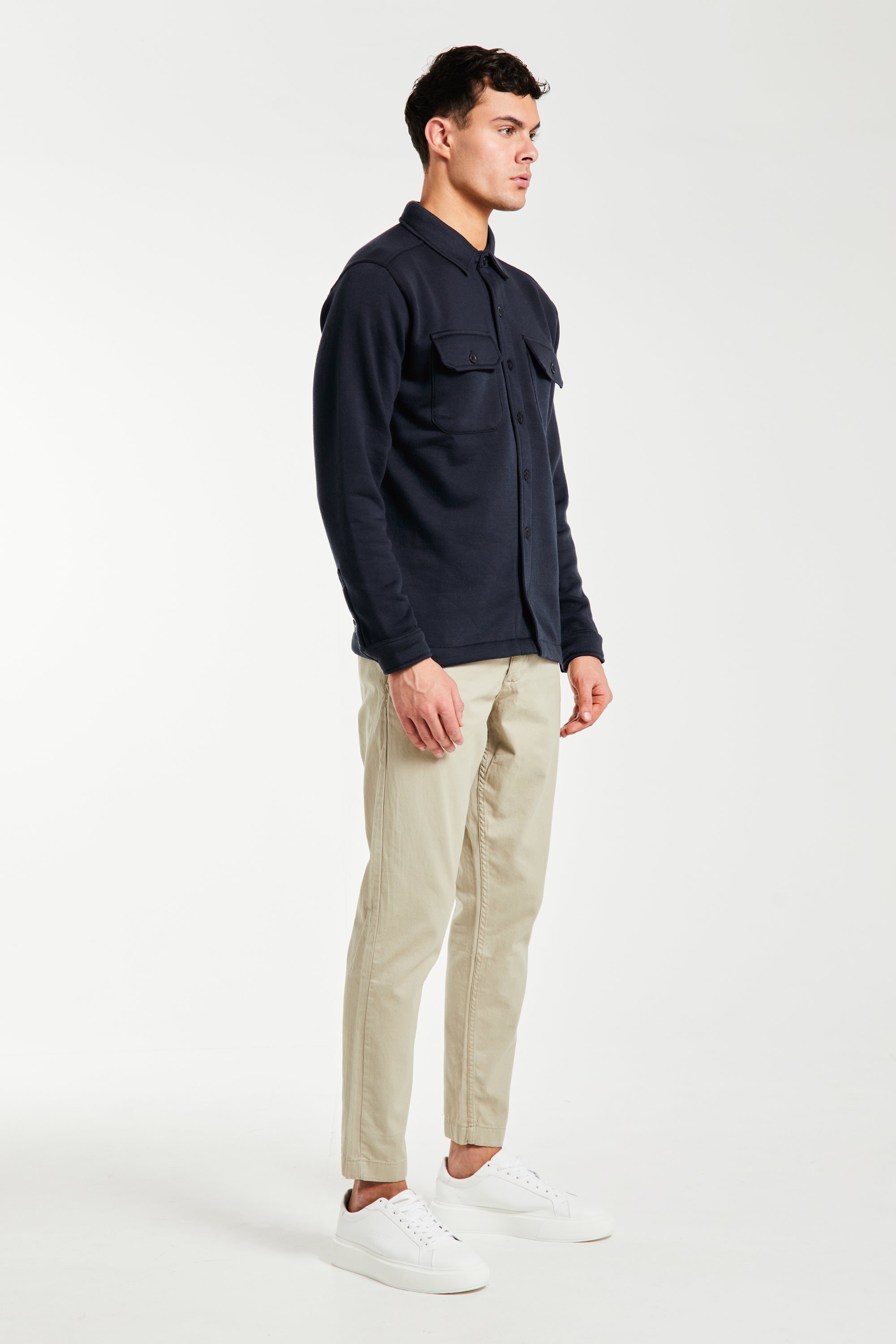 Side profile of men&#39;s chino pants in sand