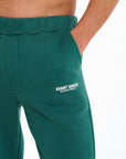 Logo detail on emerald green joggers