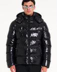 Model in sunglasses and black hooded puffer jacket