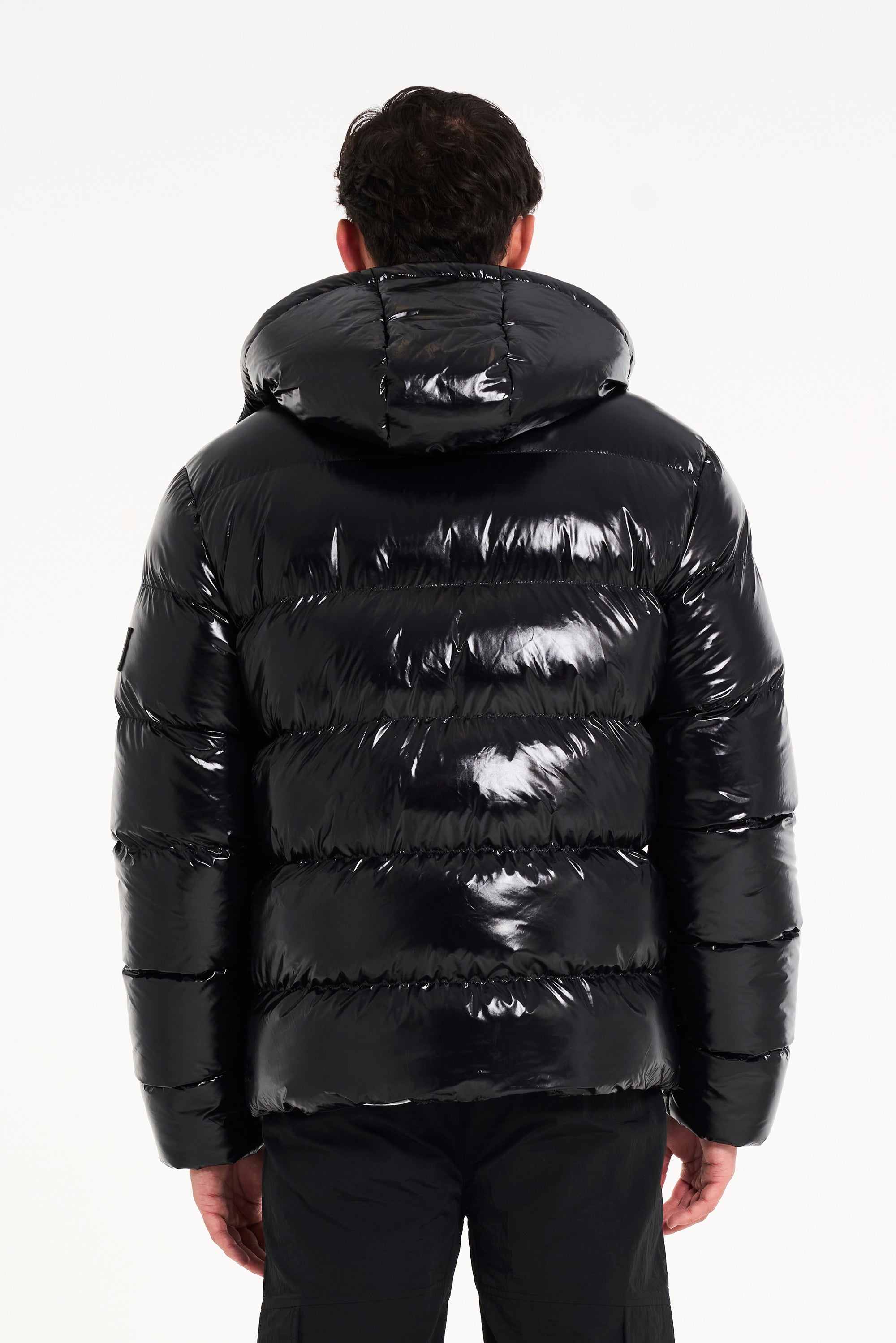 Back of hooded puffer jacket in black from Avant Garde