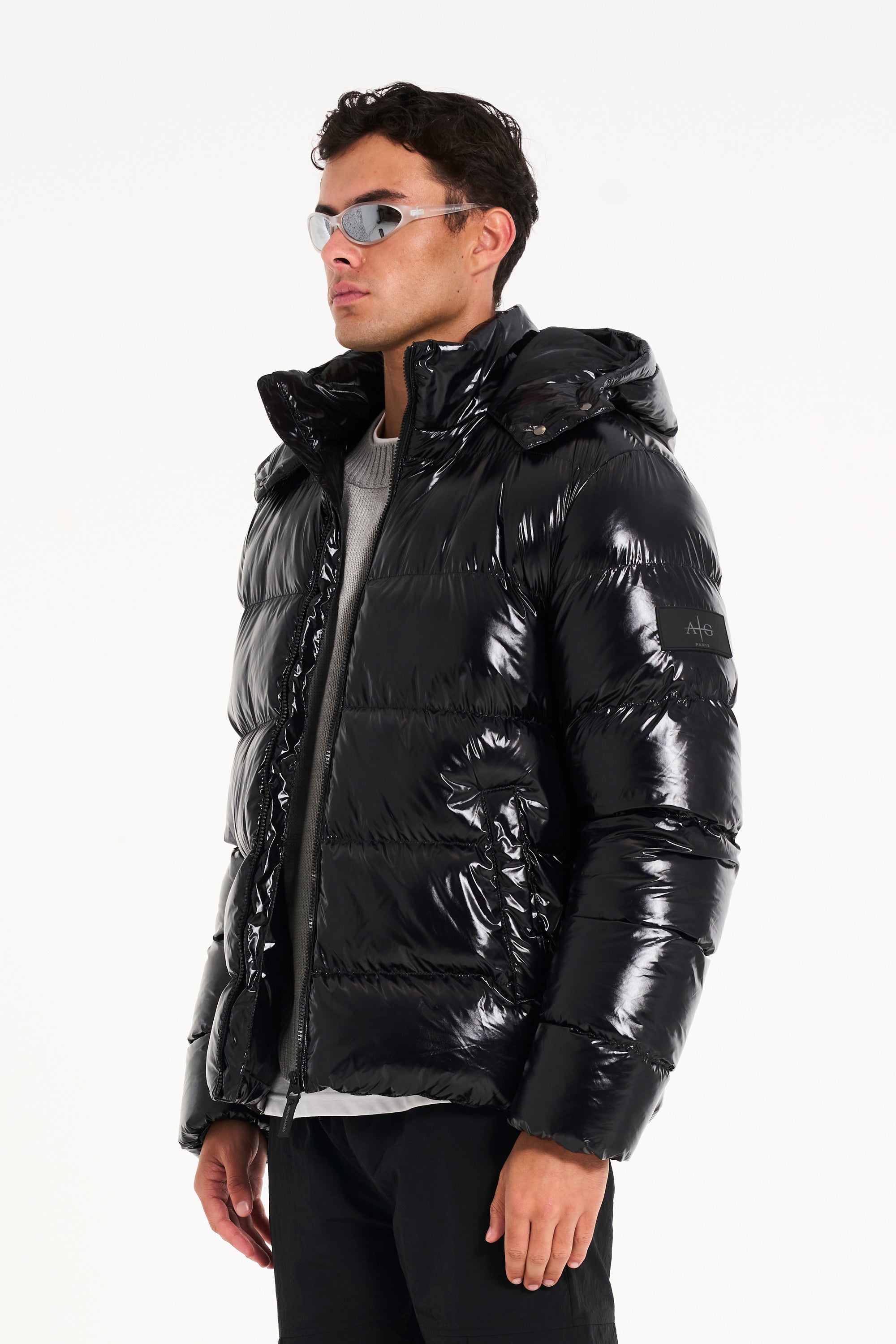 Man in sunglasses and black puffer jacket