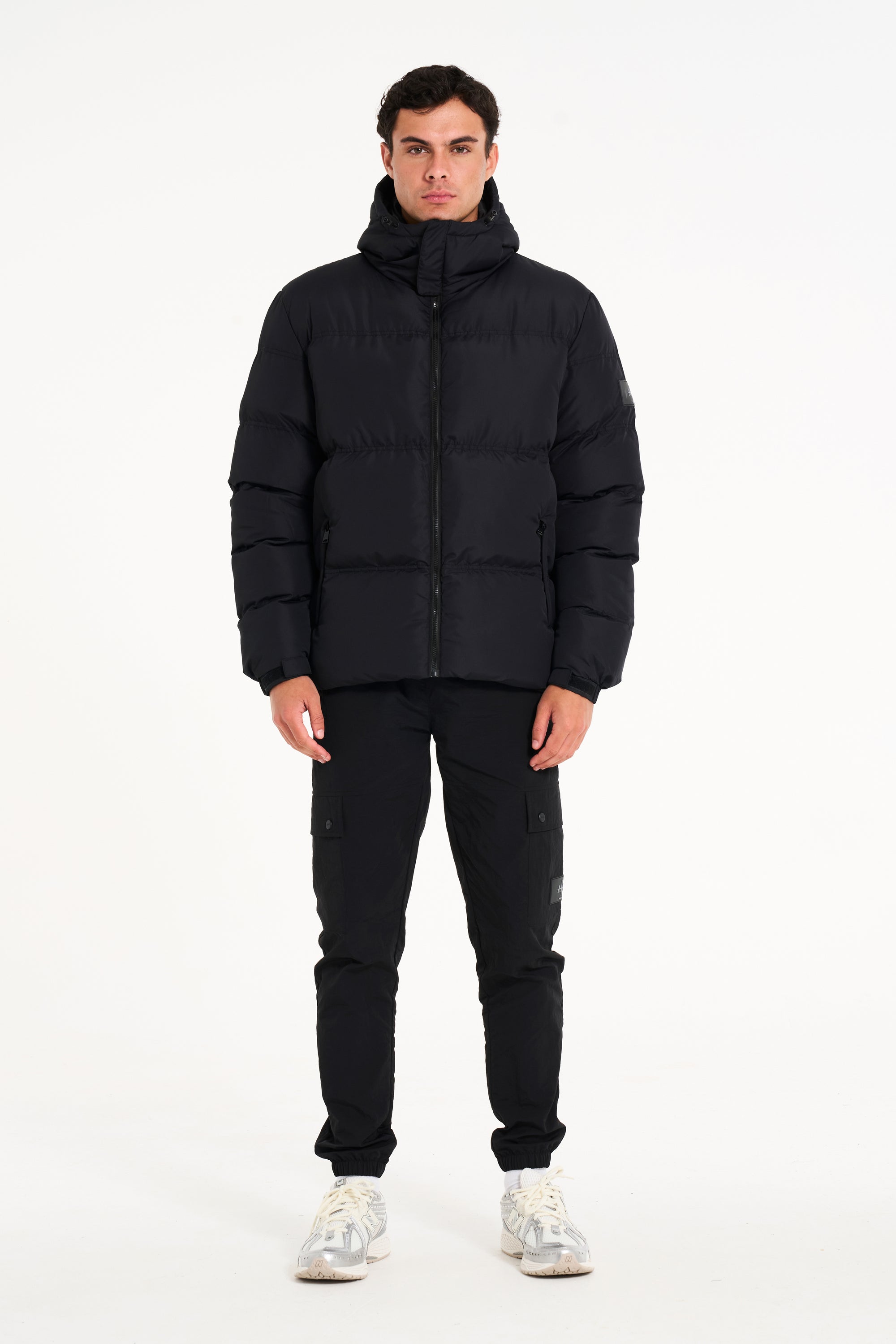 Mens black puffer jacket and cargo trousers