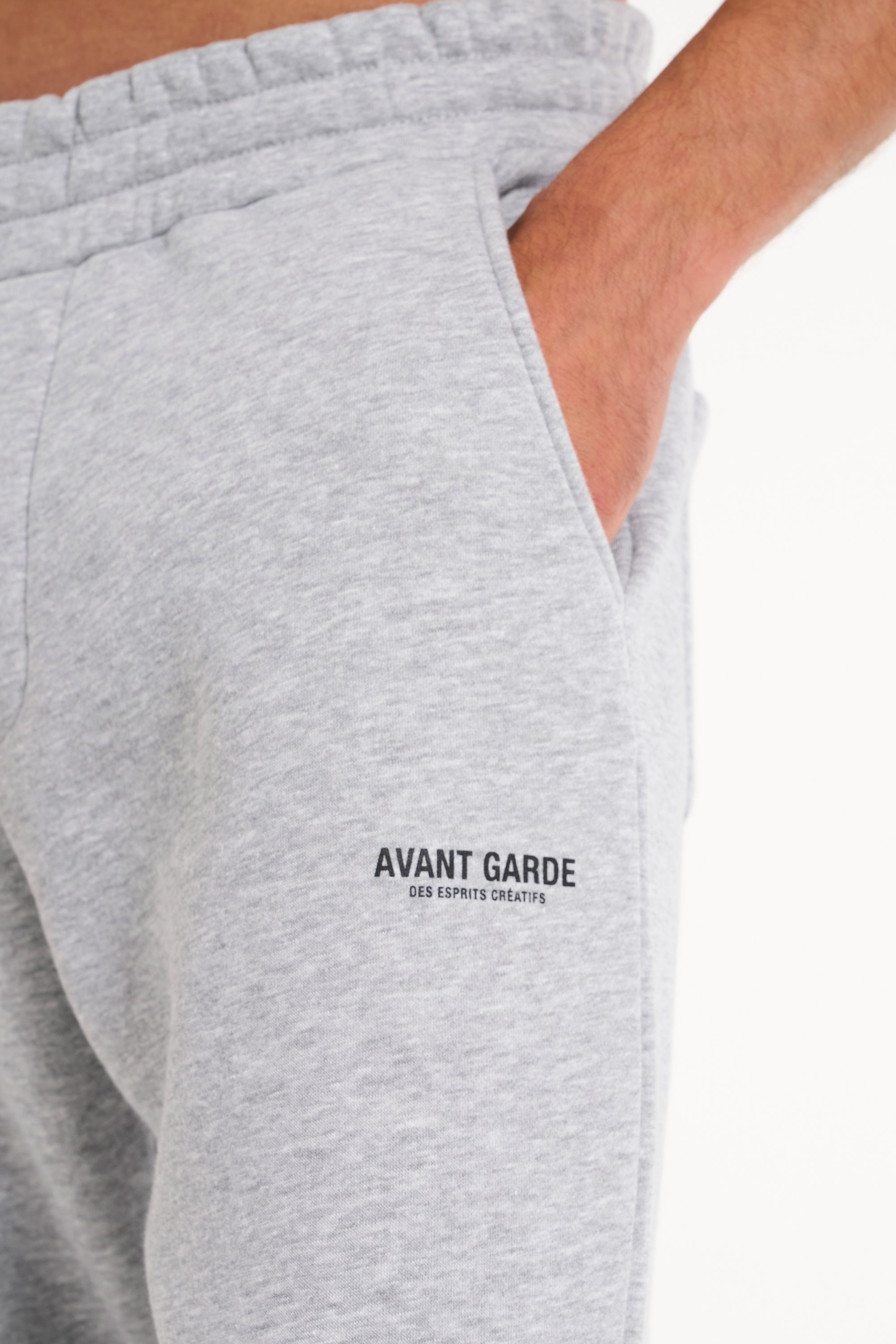 Close up shot of Avant Garde logo on the leg of grey tracksuit bottoms