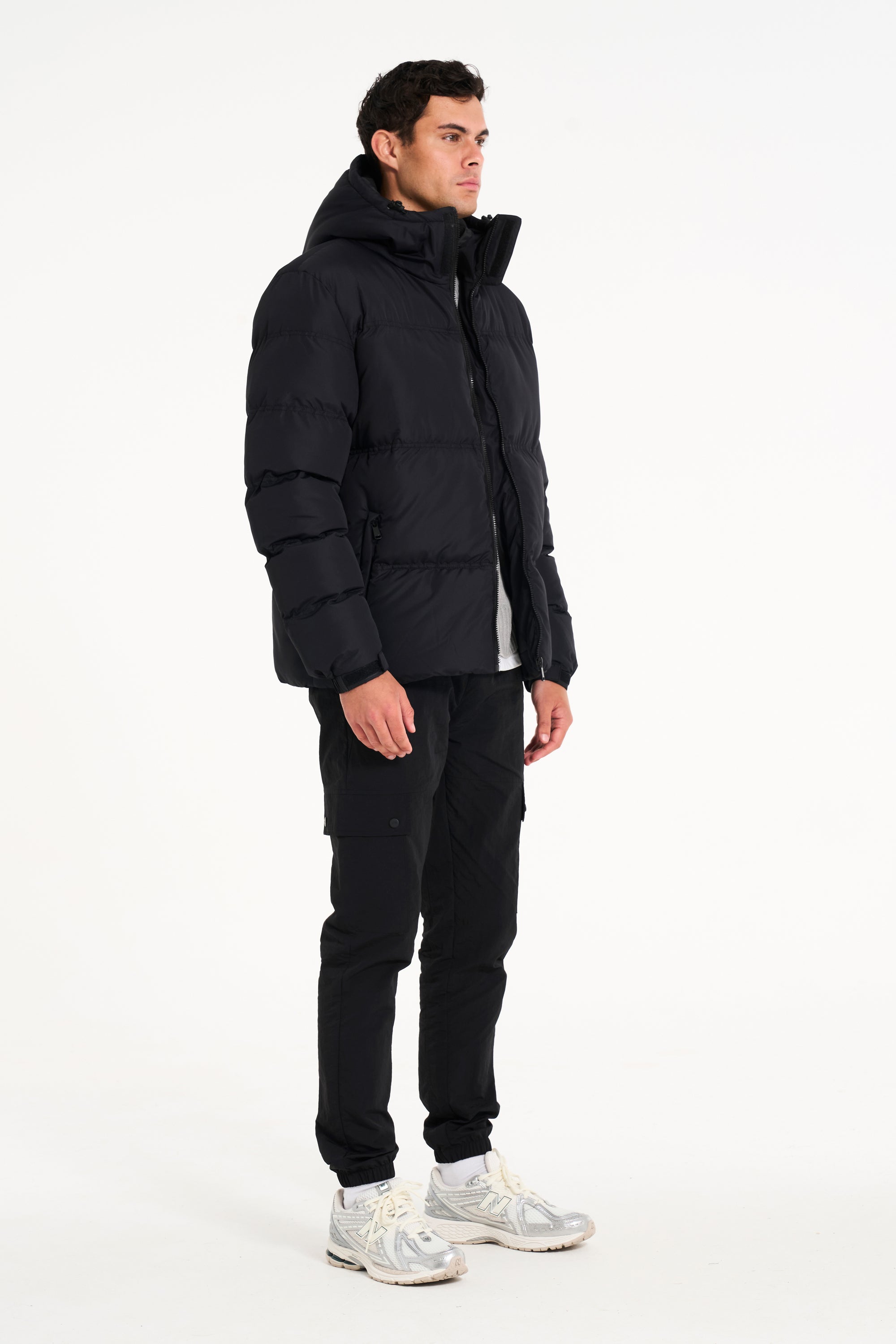 Side of mens black puffer jacket (Unzipped)