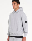 Top half of model wearing full tracksuit in grey facing to the side