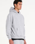 Top half of model facing to the right wearing a full men's tracksuit in grey