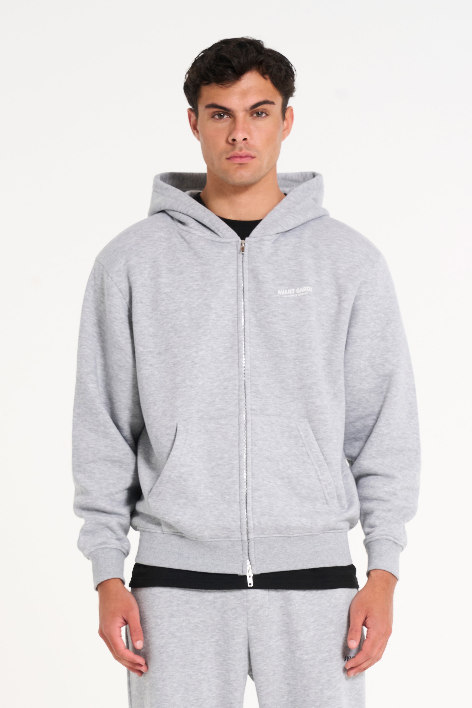 Model wearing zip up hoodie in grey