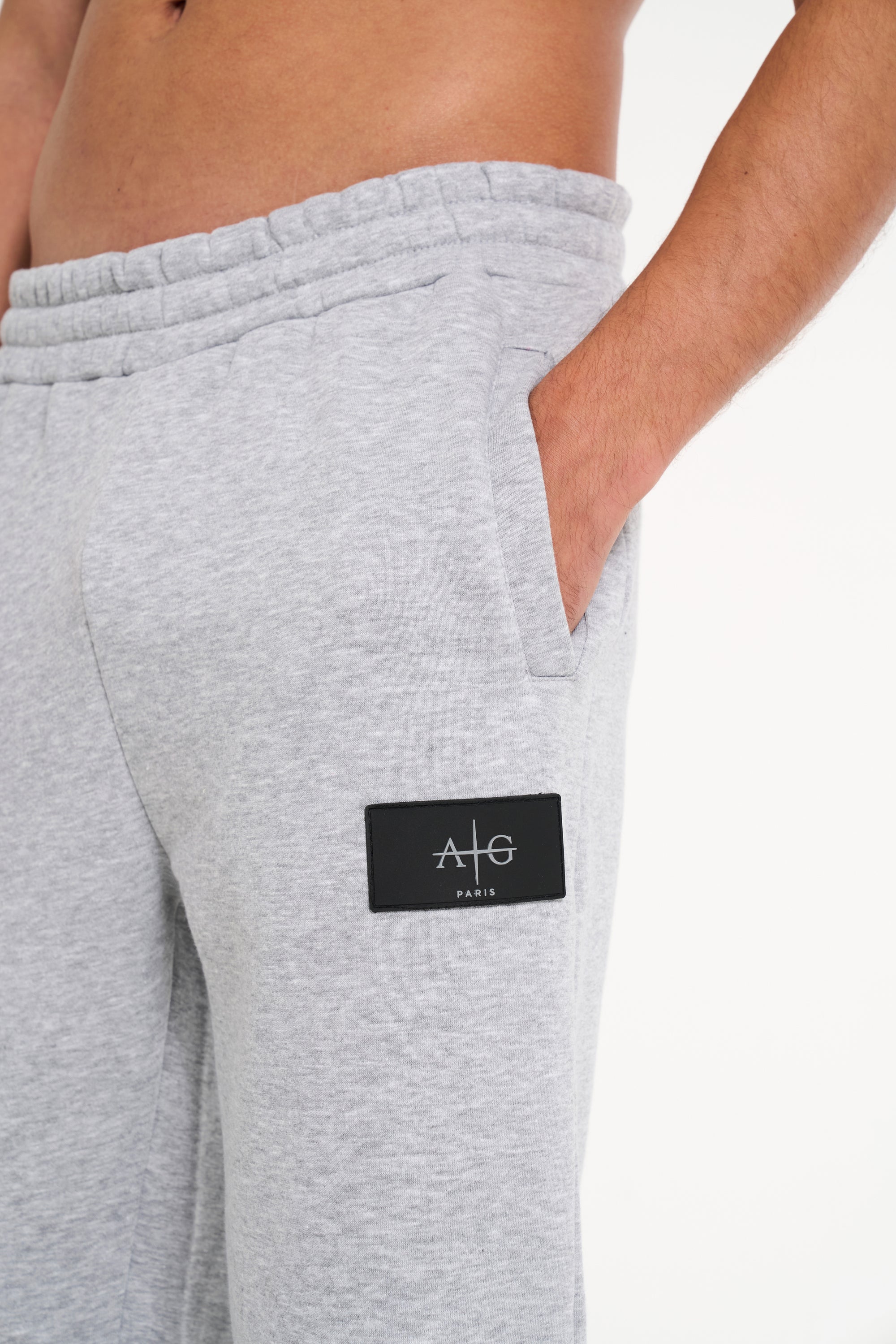 Avant Garde tracksuit bottoms showing badge logo on upper leg