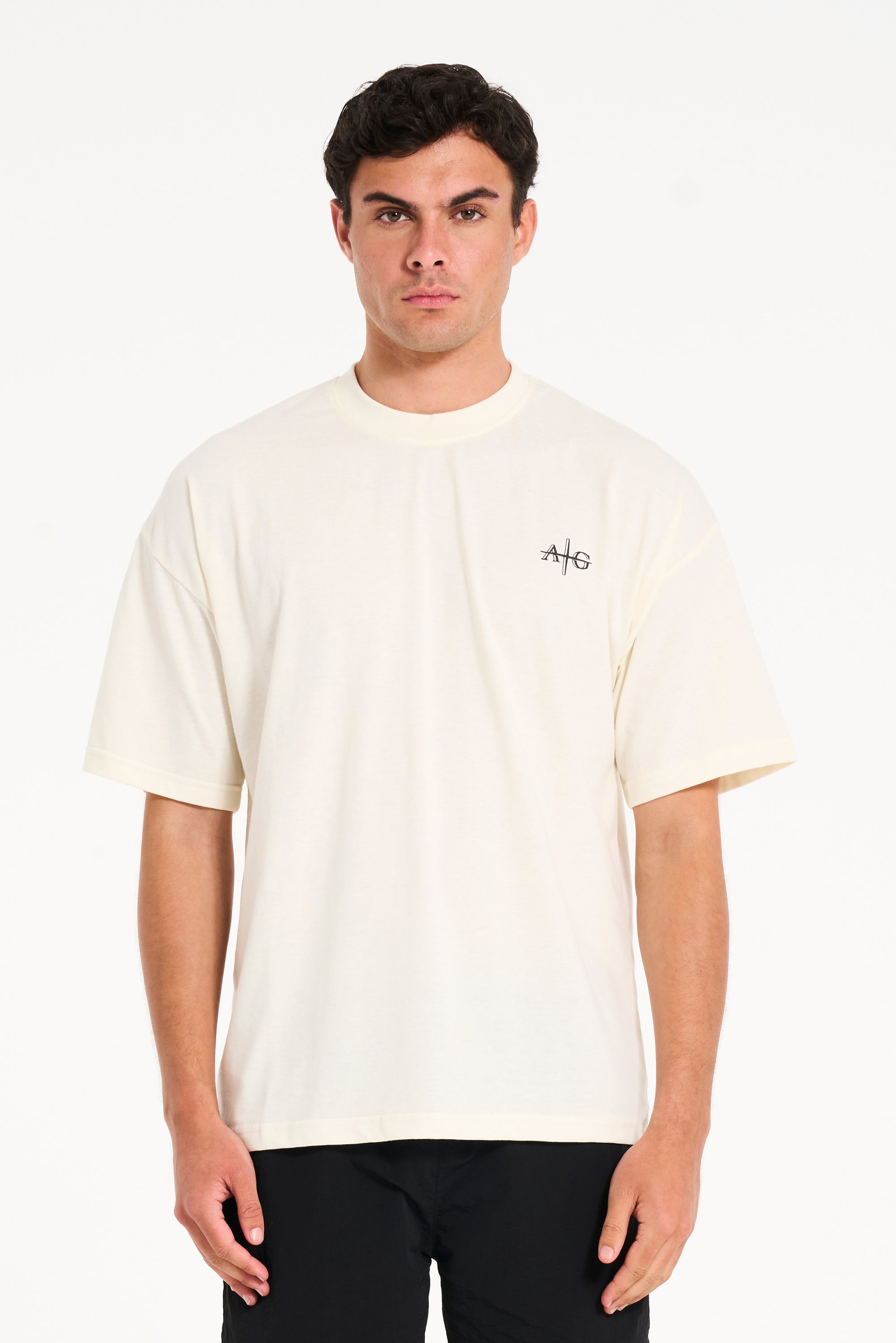 Man facing forward wearing crew neck T-shirt in ecru