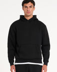 Close up frontshot of model wearing black tracksuit top with pocket