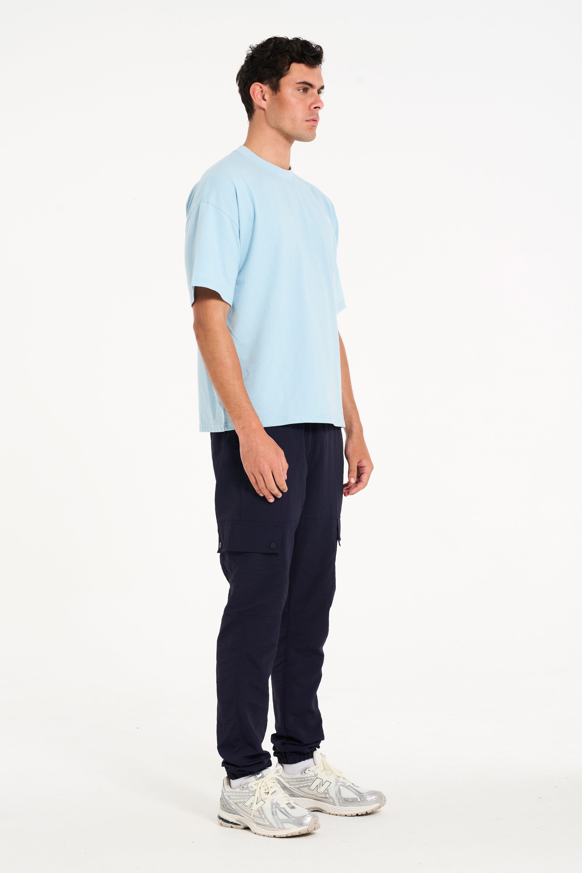 Man facing away to the right wearing sky blue crew neck T-shirt