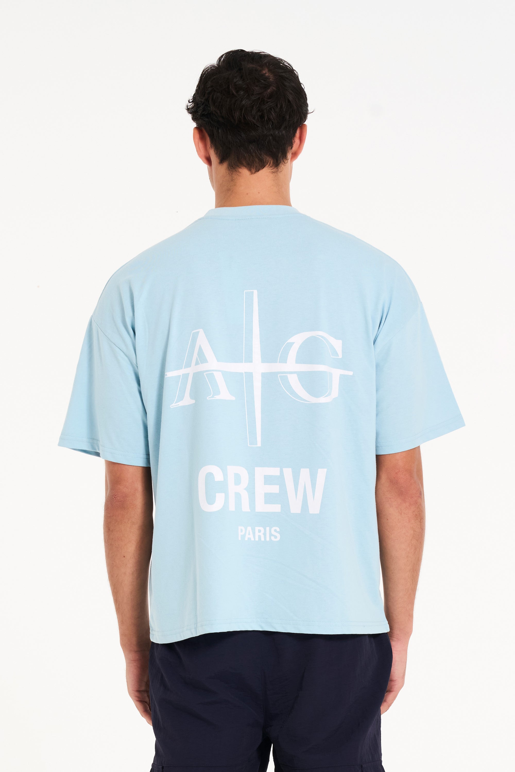 Backshot of sky blue T-shirt with Avant Garde logo and CREW writing on the back