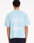 Backshot of sky blue T-shirt with Avant Garde logo and CREW writing on the back