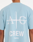 Close up backshot of sky blue T-shirt with Avant Garde logo on the back