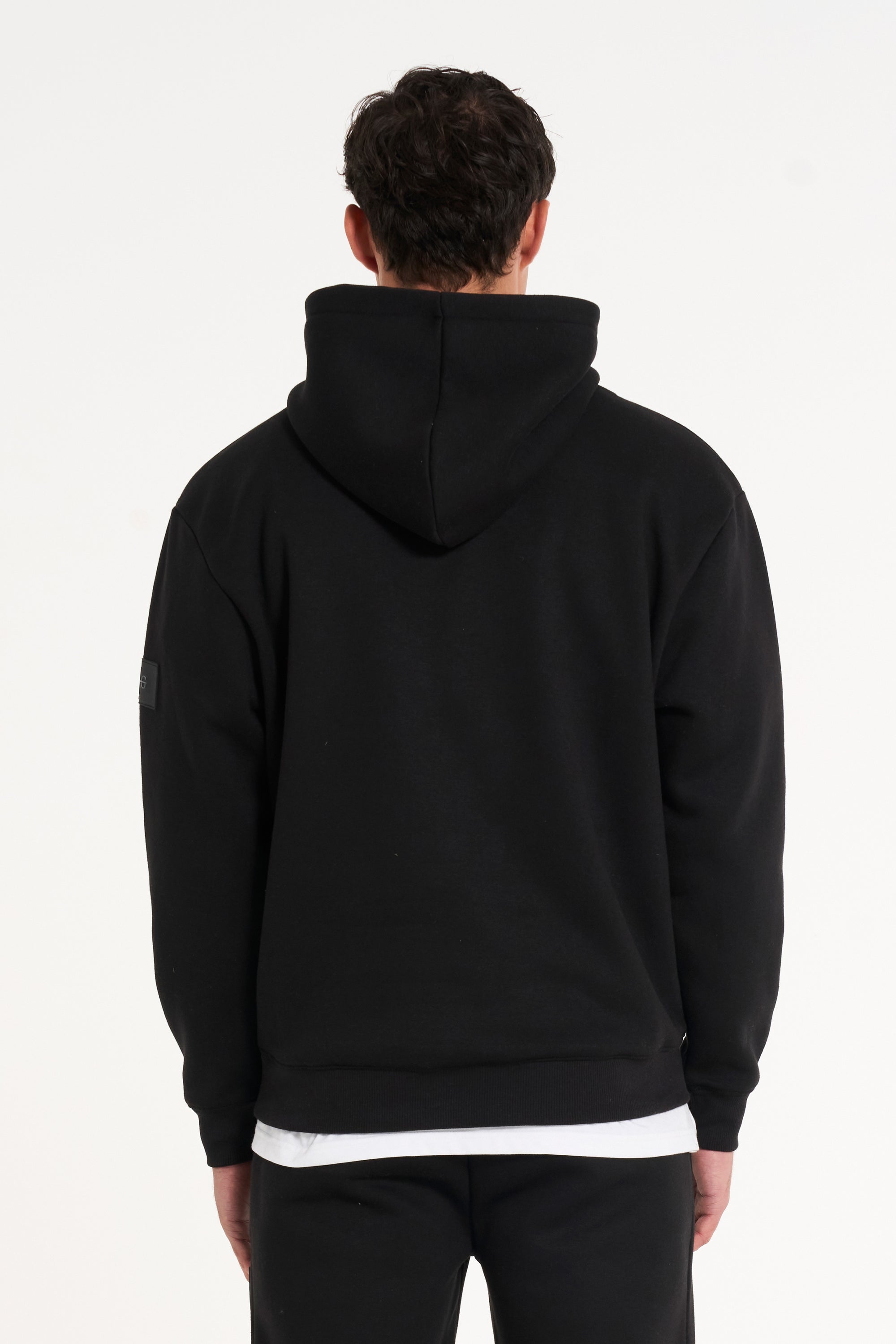 Close up backshot of model wearing full black tracksuit with hood 