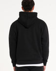 Close up backshot of model wearing full black tracksuit with hood 