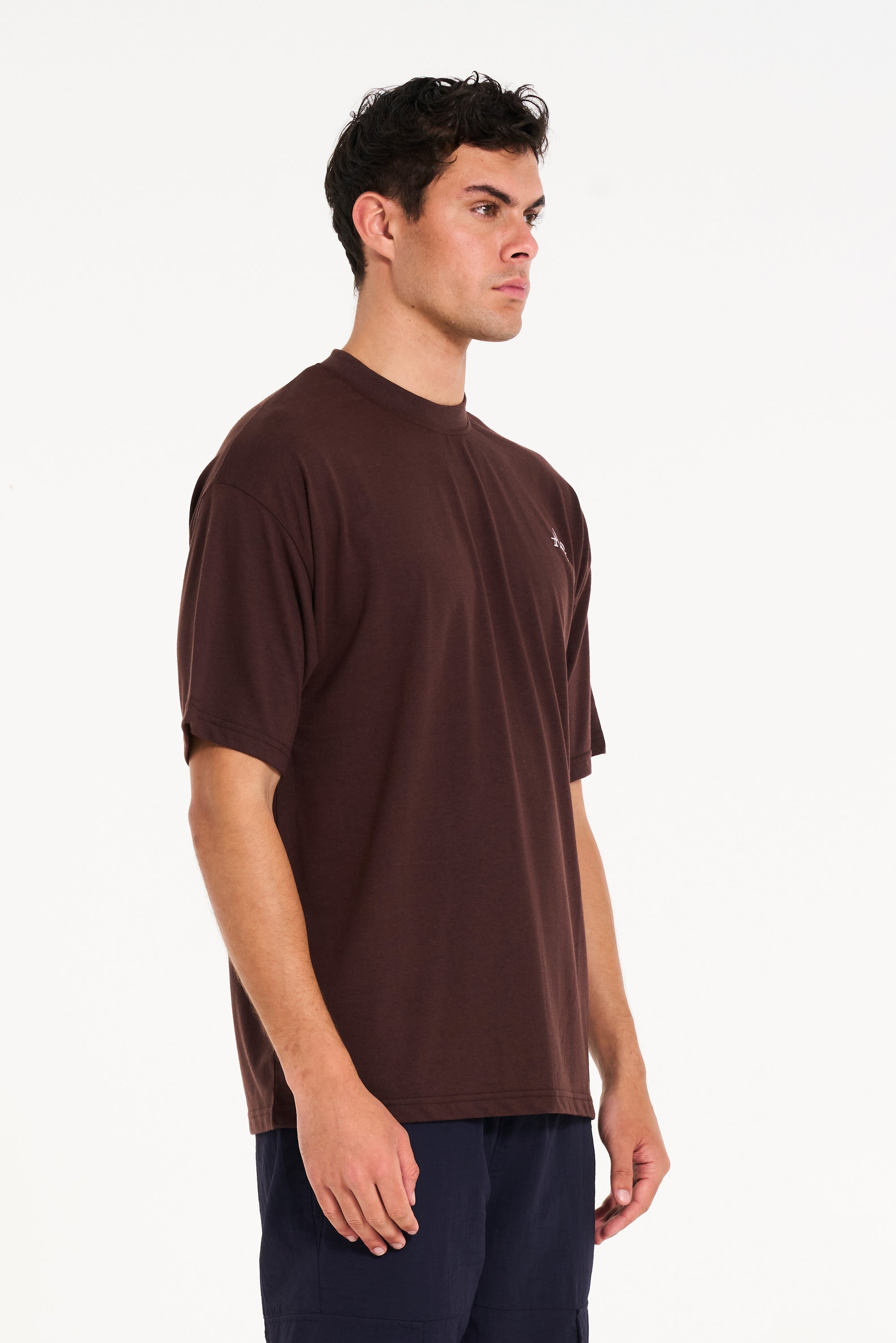 Model facing to the right wearing brown crew neck T-shirt