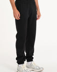 Close up side shot of plain black tracksuit bottoms in black