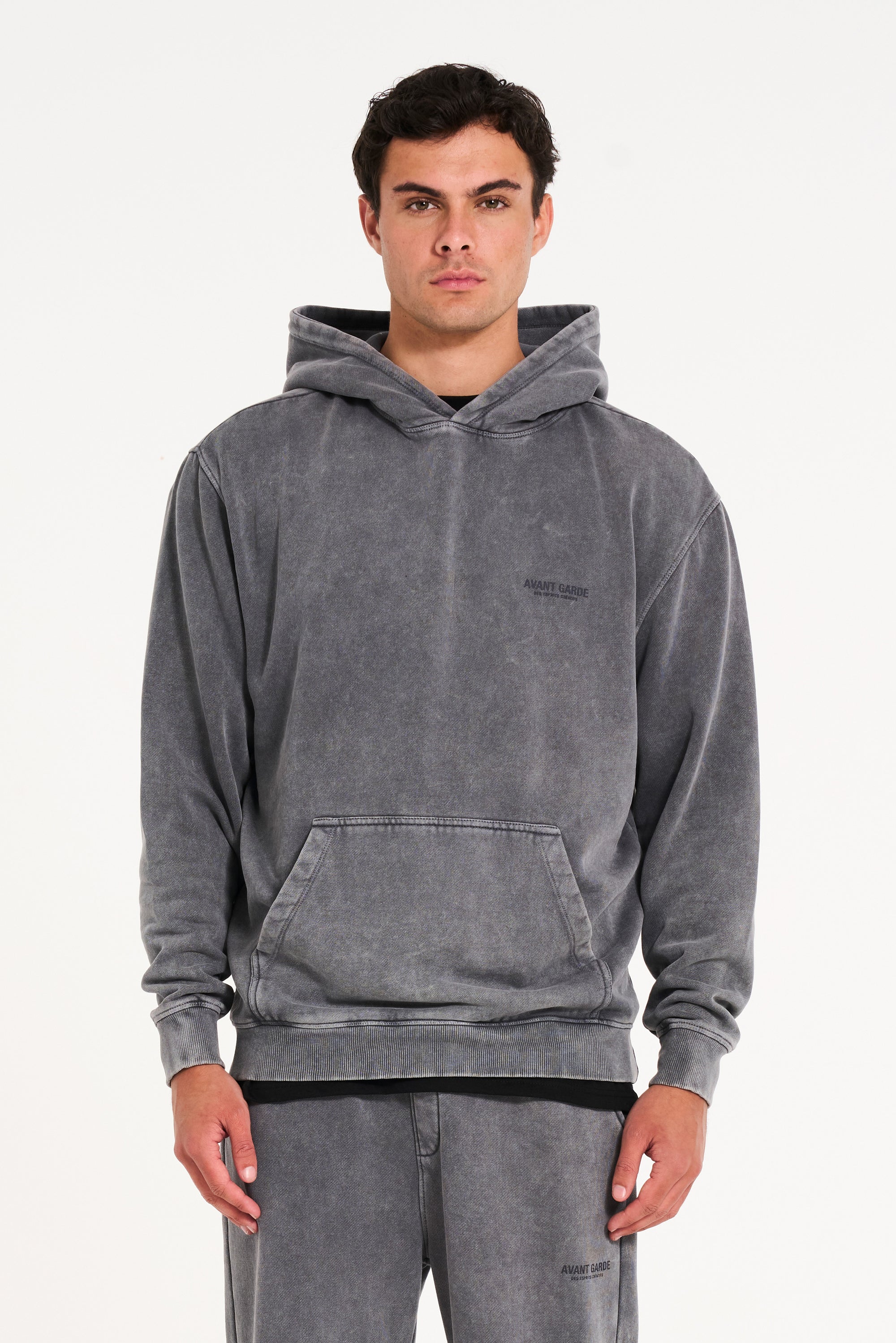 Model facing camera wearing Avant Garde hoodie in steel