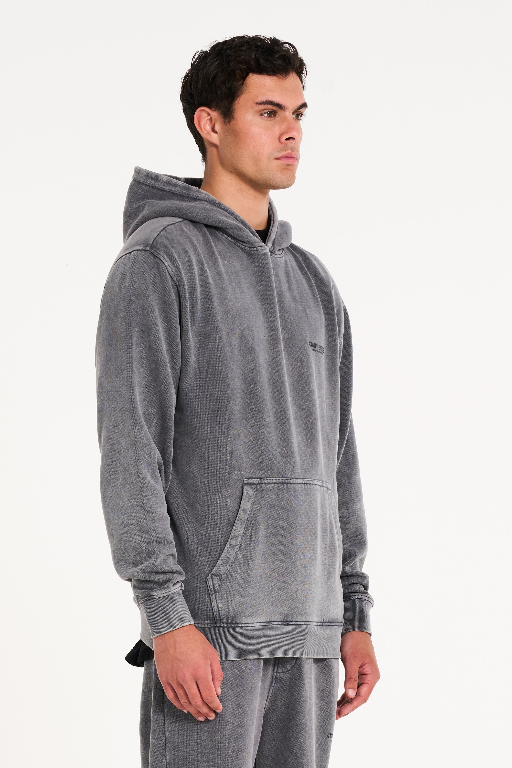 Model facing to the right wearing men's hoodie in steel