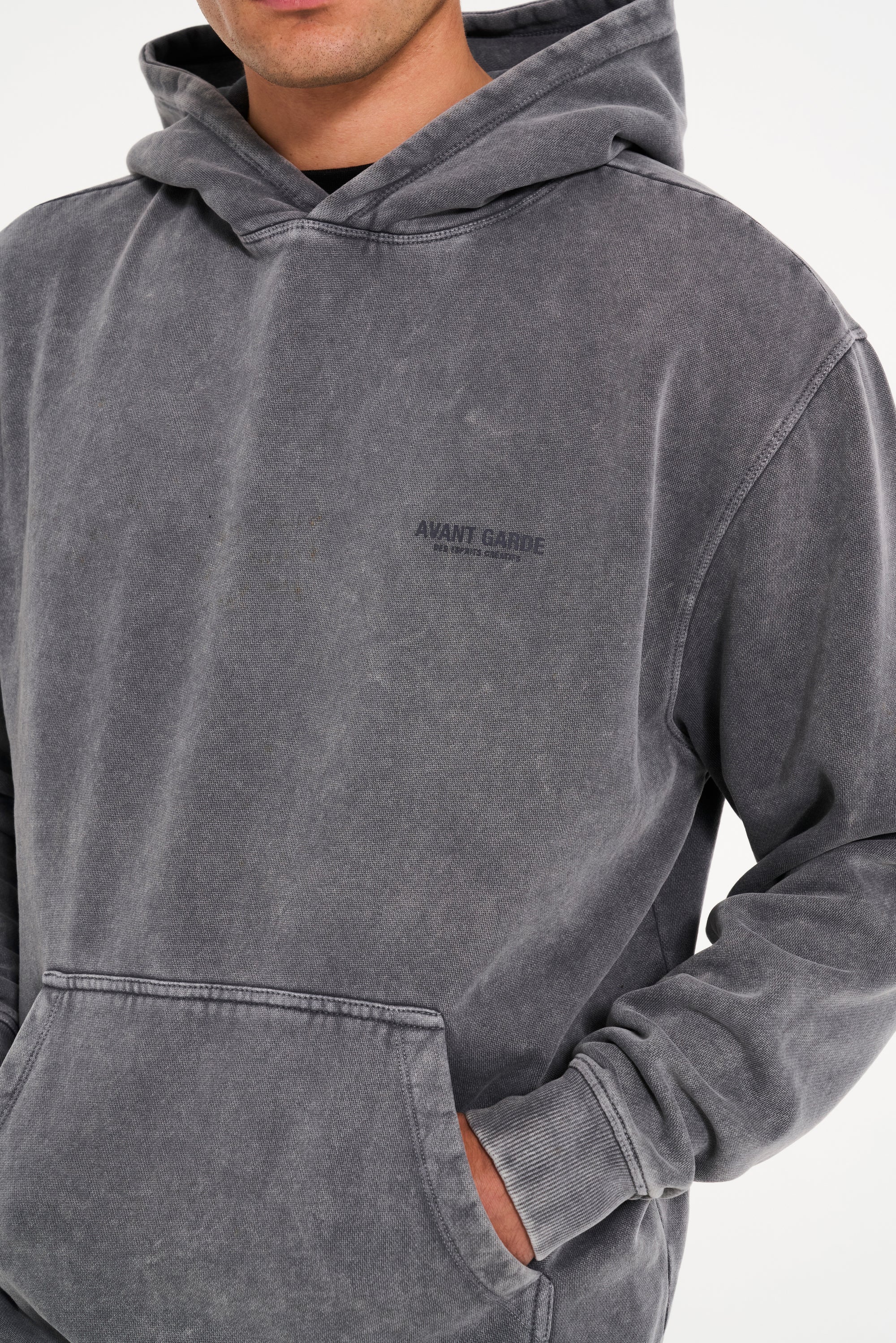 Front of Avant Garde hoodie in steel with hands in pocket