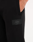 Close up shot of Avant Garde logo on black tracksuit bottoms