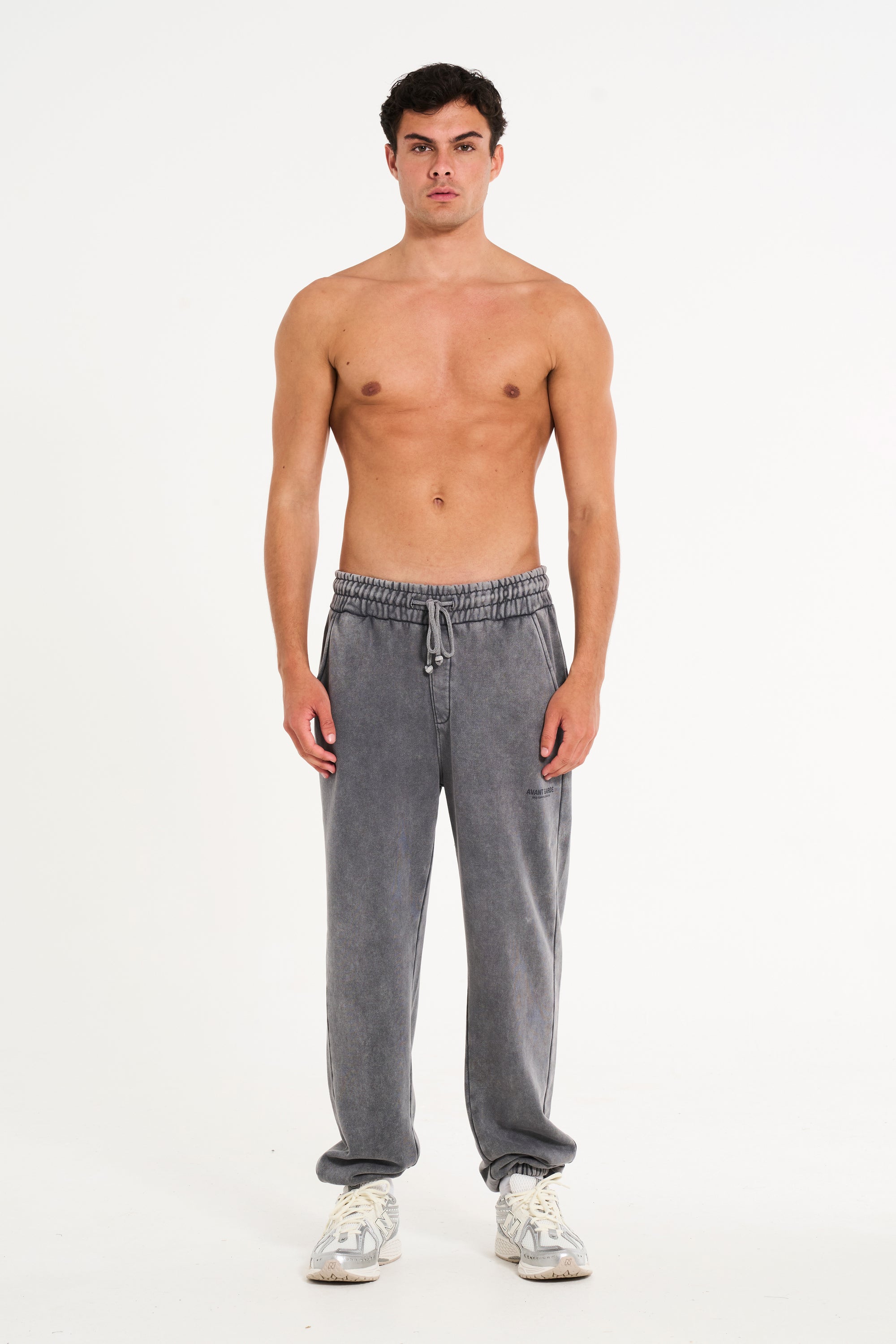 Topless model wearing steel tracksuit bottoms