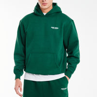model wearing emerald green hoodie