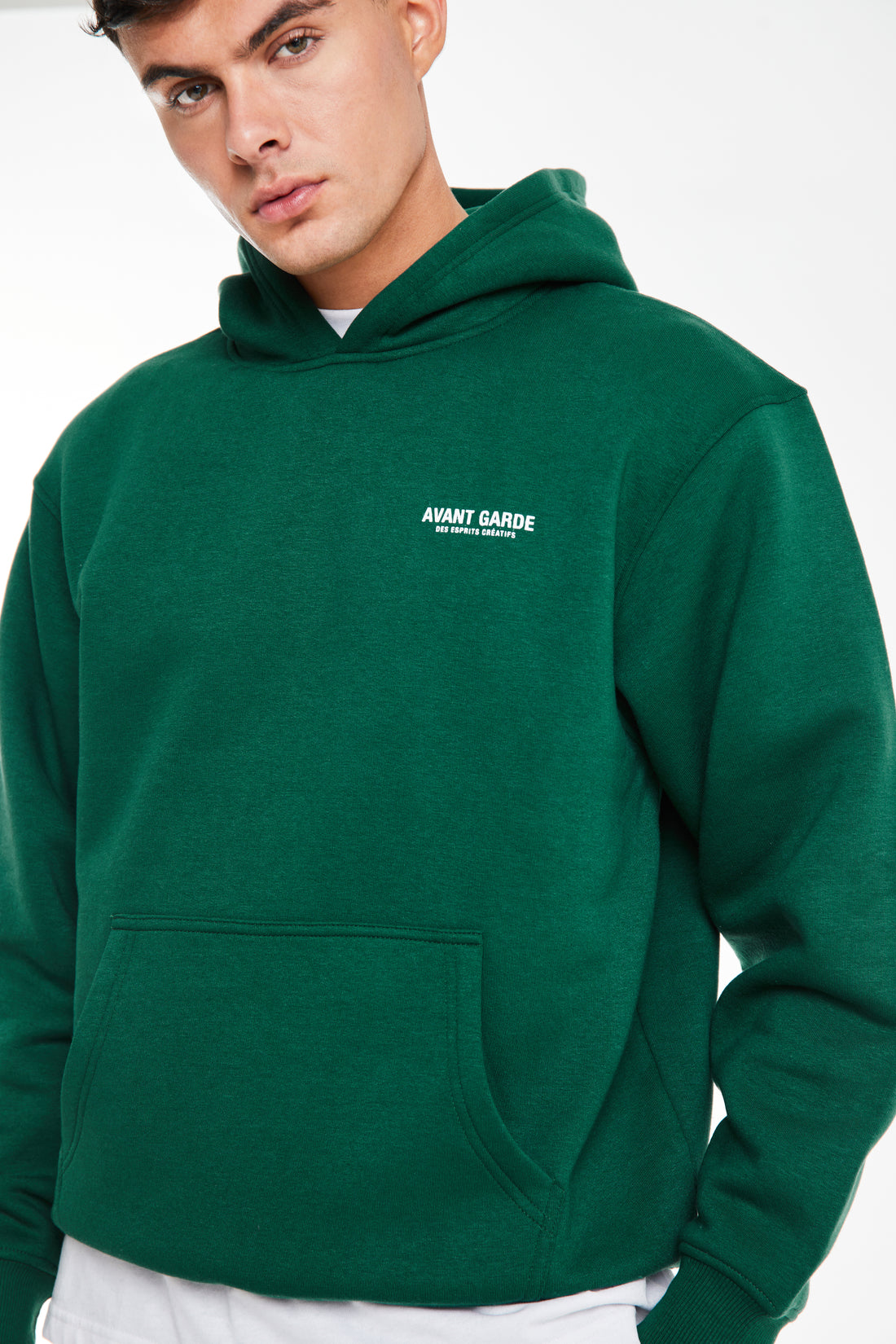close up of hoodie in forest green with logo on chest