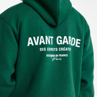 close up of 'Avant Garde' logo on back of mens hoodies in dark green