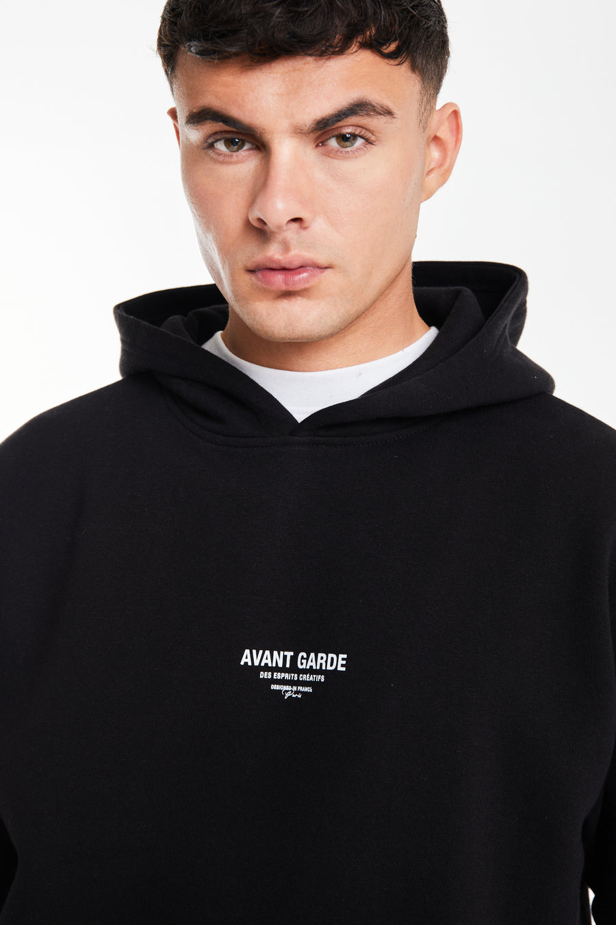 close up of 'Avant Gard Paris' logo on black men's hoodie 