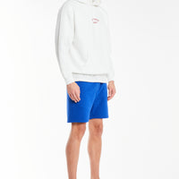 White men's hoodie with cuffed sleeves styled with shorts